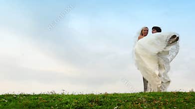 groom takes bride on hands and carries away it on