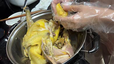 Cutting up a chicken. Tearing apart boiled chicken broiler chicken seller cutting broiler chickens on a cutting board at