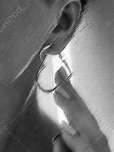 a woman\'s ear with a heart-shaped earring