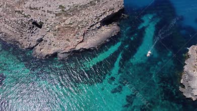 Natural windows in the rocks, Comino Island Malta, Close up revealing drone shot