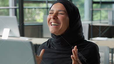 Islamic ethnic happy business woman winning online achievement celebration businesswoman in hijab in office win victory