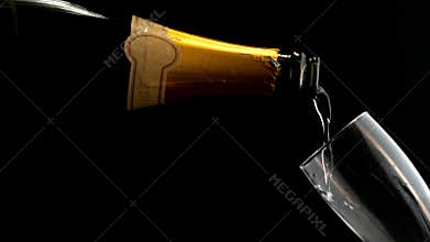 Champagne being poured from the bottle to the flute