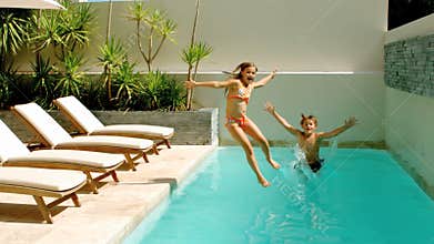 Siblings diving into the swimmingpool
