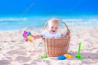 Baby in a basket on the beach