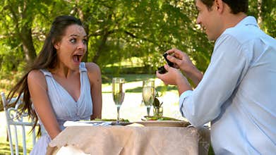 Man proposing marriage to his shocked girlfriend