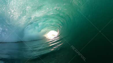 Immersive point of view inside a breaking ocean wave barrel