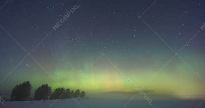 Bright northern lights dance over icy fields under starlit sky, Spectacular display of green and red auroras shimmering over