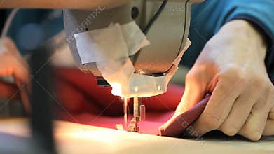 Hands sewing machine in a factory manufacturing leather
