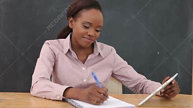 Video of a close up of a teacher using a tablet computer