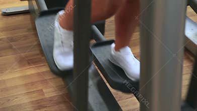 Woman using cross trainer