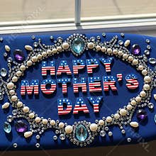 Patriotic American flag lettering spells out happy mother's day on blue decorative fabric