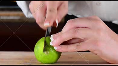 Chef slicing or cutting white onion on cutting board