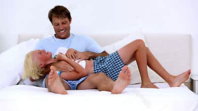 Father tickling his son