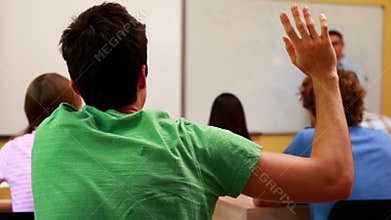 Lecturer speaking to his class and answering a question
