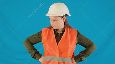 Responsible female engineer in helmet explains duties