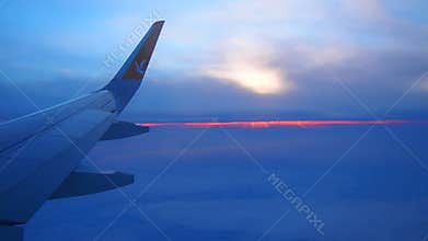 Istanbul, Turkiye - January 24, 2026: Pegasus Airlines Plane Wing Over Evening Clouds. Sunset Peeking Through Haze. Aircraft