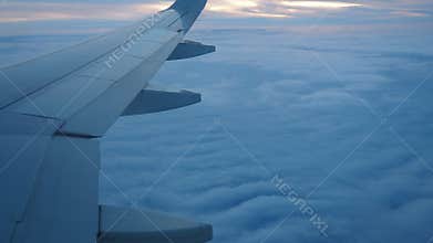 Istanbul, Turkiye - January 24, 2026: Pegasus Airlines Plane Wing Over Evening Clouds. Sunset Peeking Through Haze. Aircraft