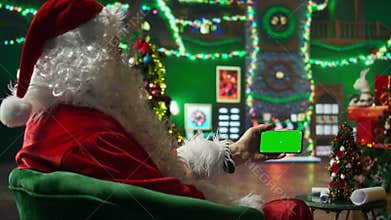 Person wearing Christmas costume amused by social media posts on mockup phone