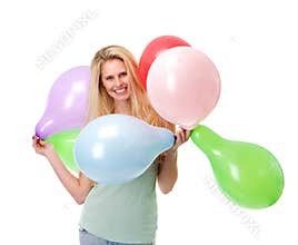 Happy young woman holding balloons
