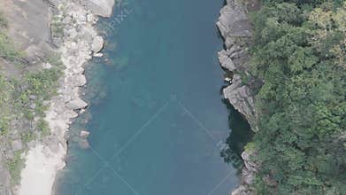 Stunning top-down aerial view of the crystal-clear Umngot River in Shnongpdeng, Meghalaya, revealing the rocky riverbed below