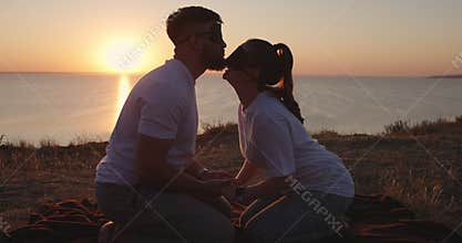 A couple kisses with their eyes blindfolded