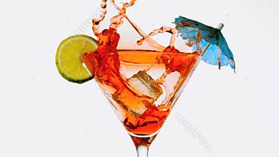 Ice cube falling into cocktail