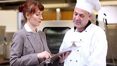 Restaurant manager speaking with head chef