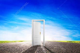 Open door on long empty asphalt road towards sun.