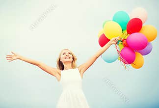 Woman with colorful balloons outside