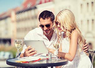 Couple looking at tablet pc in cafe