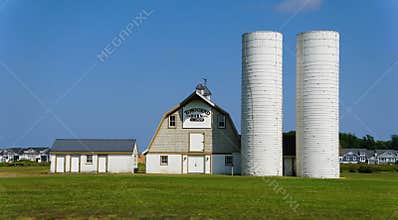 Cape Henlopen, Delaware, U.S - Sept 3, 2025 - The front view of the Townsend Barn framed by a vibrant blue sky and grassy field on