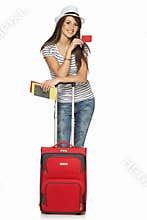 Female in casual standing with travel suitcase