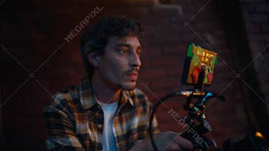 Professional videographer filming club performance in dark atmosphere closeup.