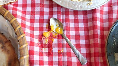 food spilled on a checkered tablecloth