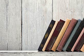 Book shelf blank spines, empty binding stand on wood texture
