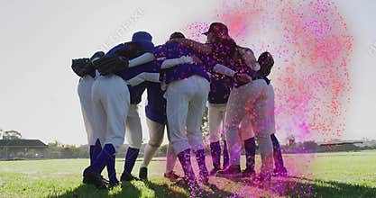Forming huddle seven female baseball teammates bending inward on grass, wearing gloves