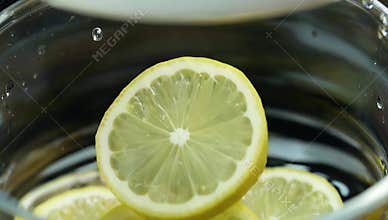 Fresh lemon slices in a glass bowl create a vibrant and refreshing citrus fruit display