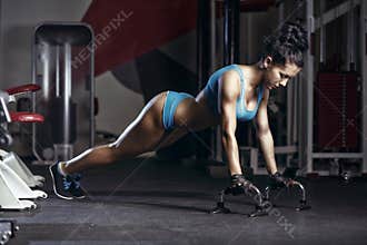 Fitness woman doing push up in the gym