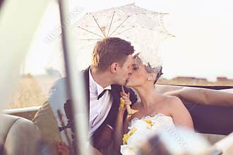 Bride and groom in a vintage car