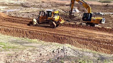 Moscow, Russia - May 19, 2025: JCB bulldozer and excavator working in unison