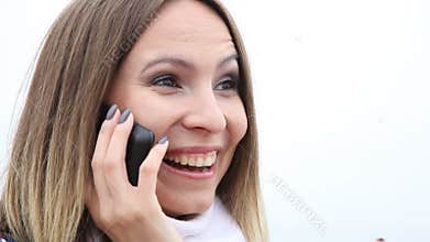 Happy girl talking on cell phone and showing okay