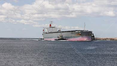 Coal freighter with tugboats