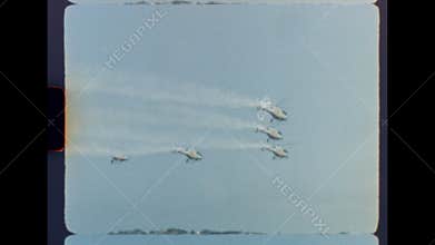 Helicopter aerobatics in blue sky with vintage super 8 film look