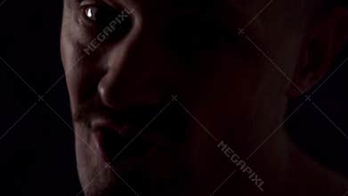 Portrait of an athletic guy on a dark background