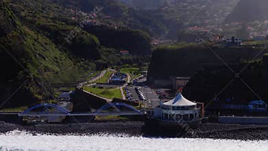 Aerial Madeira coastline, blue arched bridges and seaside pavilion