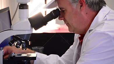 Man analyzing with a microscope