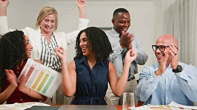 Diverse Business Team Celebrates Success with Joyful Clapping and Papers in Office