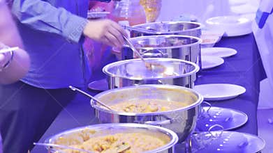 buffet table is filled with several long, rectangular serving dishes, all containing a variety of savory food.