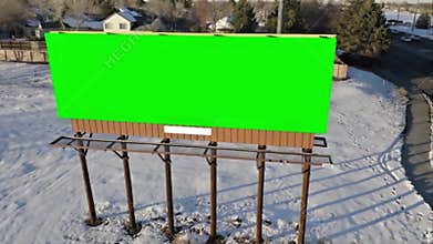 Green Screen Billboard in Snowy Winter Landscape Aerial View