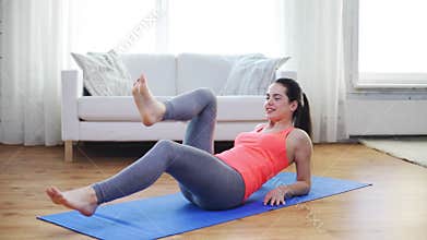 Smiling teenage girl doing exercise for legs